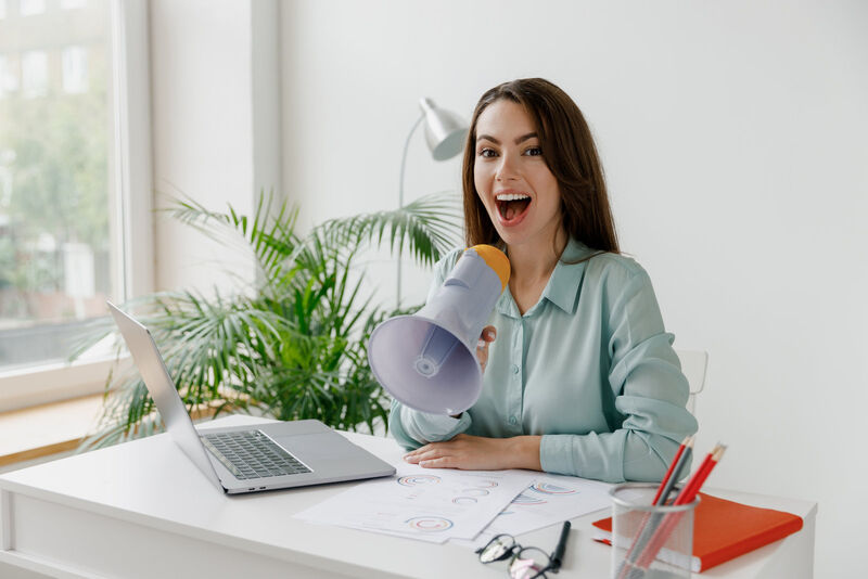 Use Simplelists for either announcement emails or discussions Photo of a business woman making an announcement in front of a computer with a megaphone