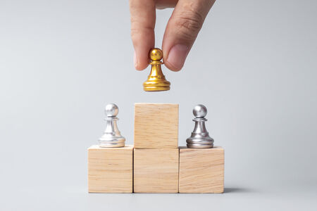 Image of blocks with golden chess piece on the top